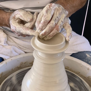 Pottery Mandurah teacher throwing lid off the hump on pottery wheel